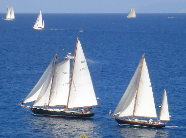 Note crew on the bow checking sail trim.